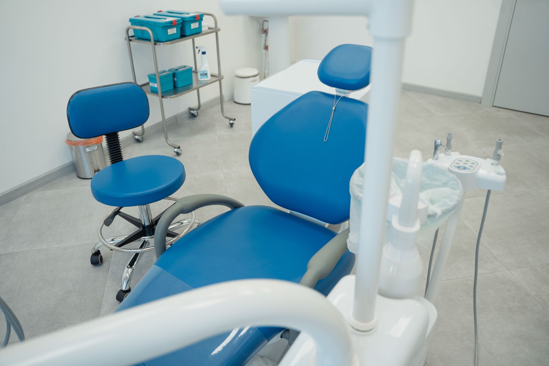 Empty blue dental chair in a clean treatment room