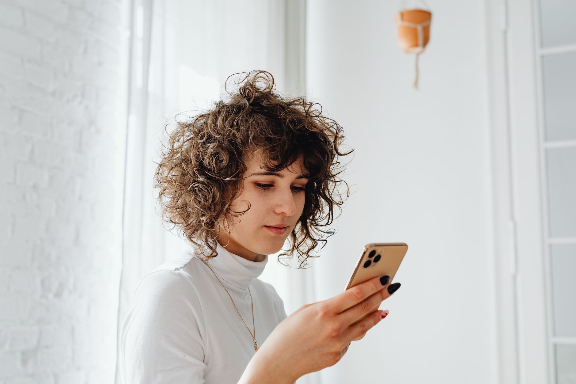Woman reading a text message on her smartphone at home